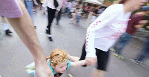 A Girl With A Crown On Her Head Is Being Held By A Woman GIF