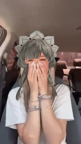 A Girl With A Crown On Her Head Is Covering Her Mouth With Her Hands GIF