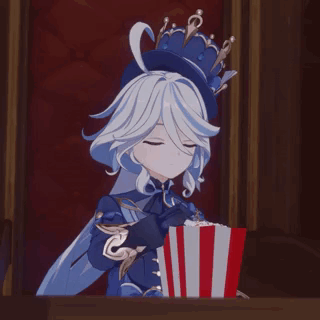 A Girl With A Crown On Her Head Is Holding A Box Of Popcorn . GIF