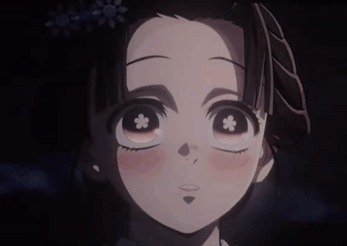 A Girl With A Flower In Her Eye Is Smiling GIF