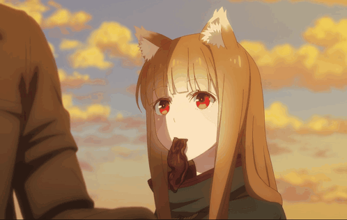 a girl with a fox ear is holding a piece of chocolate in her mouth