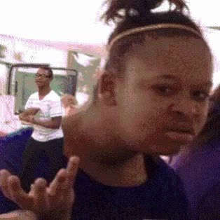 A Girl With A Headband On Her Head Making A Funny Face GIF