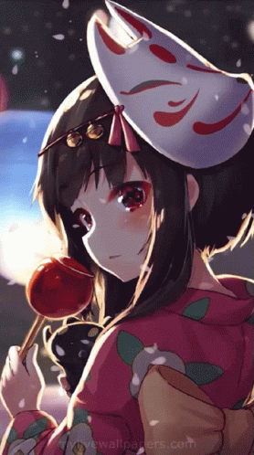 A Girl With A Mask On Her Head Is Holding A Red Candy GIF