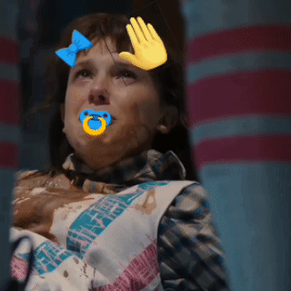 A Girl With A Pacifier In Her Mouth And A Hand On Her Face GIF