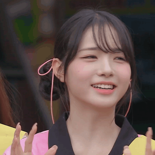 A Girl With A Pink Bow In Her Hair Smiles GIF