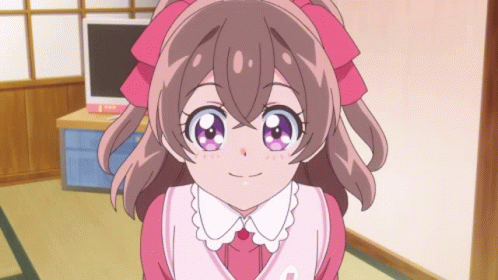 A Girl With A Pink Bow On Her Head Is Smiling GIF