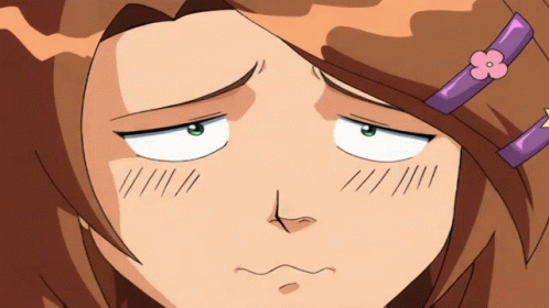 A Girl With A Purple Flower In Her Hair Makes A Funny Face GIF