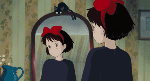 Girl With Red Bow Looking In Mirror GIF