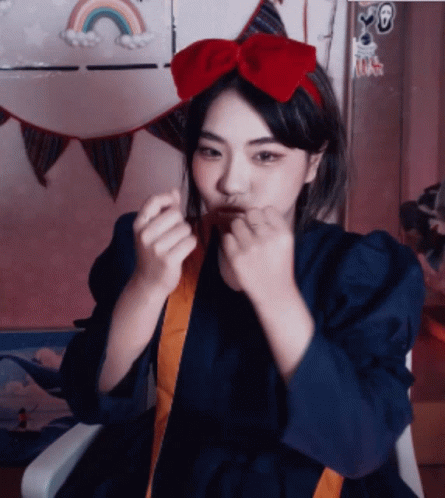 A Girl With A Red Bow On Her Head GIF