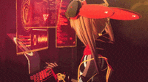 A Girl With A Red Scarf Around Her Neck Is Standing In Front Of A Monitor GIF