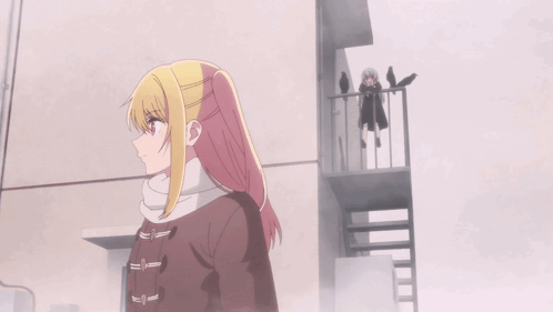 A Girl With A Scarf Around Her Neck Has The Letter S On It GIF