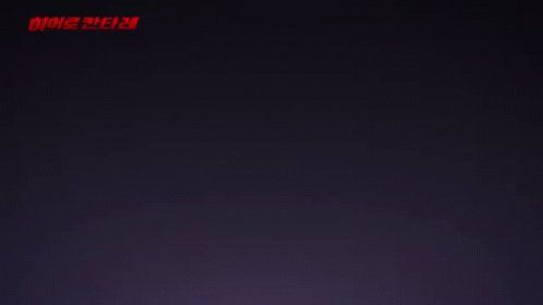 A Girl With A Star In Her Hand Stands In Front Of A Red Light GIF