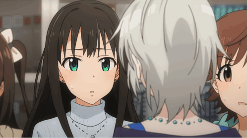 A Girl With A Turtleneck And A Necklace Looks At Another Girl GIF