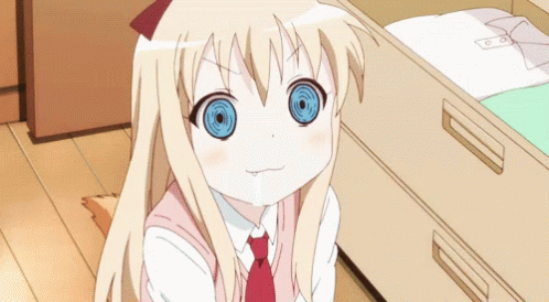 A Girl With Blonde Hair And Blue Eyes Is Sitting Next To A Drawer GIF