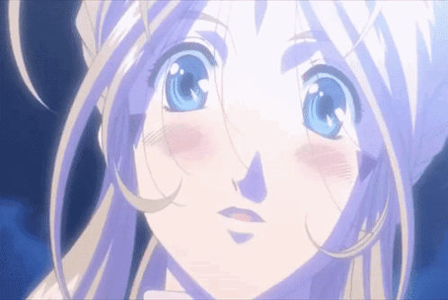 A Girl With Blonde Hair And Blue Eyes Looks At The Camera GIF