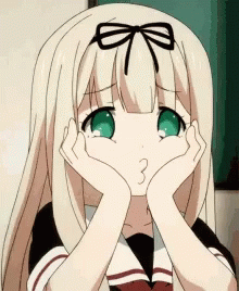 A Girl With Blonde Hair And Green Eyes Is Making A Face With Her Hands On Her Face GIF