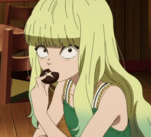 A Girl With Blonde Hair Is Eating A Cookie With A Star On It GIF