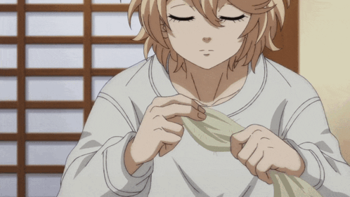 A Girl With Blonde Hair Is Holding A Piece Of Cloth In Her Hands GIF