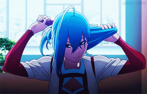 A Girl With Blue Hair Is Brushing Her Hair With A Brush GIF