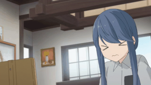 A Girl With Blue Hair Is Making A Funny Face In A Room GIF