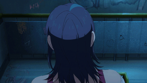 A Girl With Blue Hair Is Screaming In Front Of A Wall That Has Graffiti On It GIF