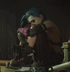 A Girl With Blue Hair Is Sitting On A Table With Her Head On Her Knees GIF