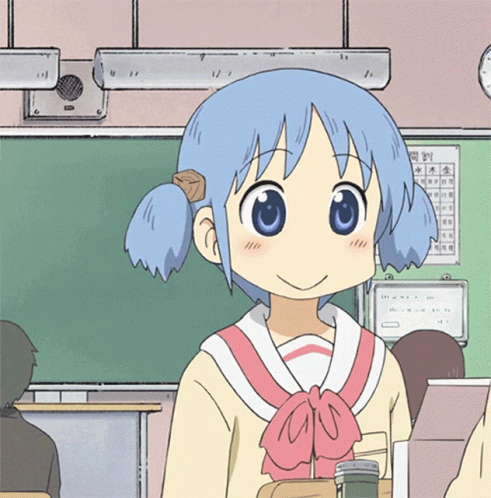 A Girl With Blue Hair Is Smiling In A Classroom With A Calendar On The Wall Behind Her GIF