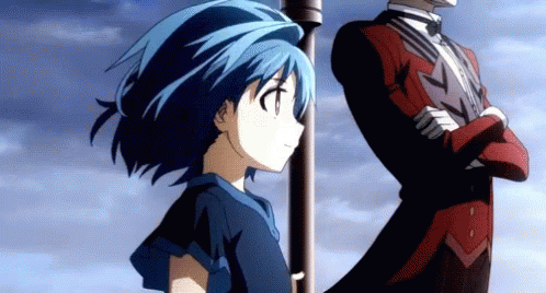A Girl With Blue Hair Stands Next To A Man In A Tuxedo GIF