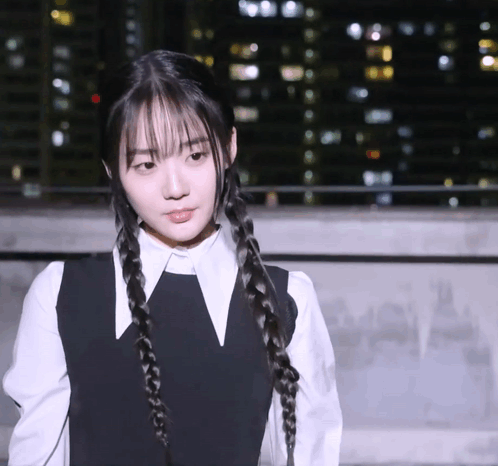A Girl With Braids And A White Shirt Has A V On Her Collar GIF