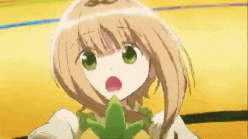 A Girl With Brown Hair And Green Eyes Is Holding A Green Object In Her Mouth GIF