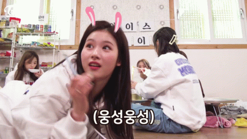 A Girl With Bunny Ears On Her Head Is Sitting On The Floor With Other Girls .. GIF
