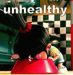 A Girl With Candy In Her Hair Is Sitting In A Red Bowl With The Words Unhealthy Written Above Her GIF