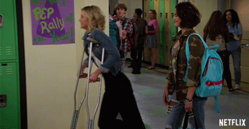 Girl With Crutches Walking Past Netflix Ad GIF