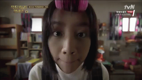 A Girl With Curlers In Her Hair Looks At The Camera With Tvn Written On The Bottom GIF