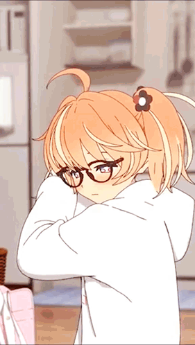 a girl with glasses and a flower in her hair is standing in a kitchen
