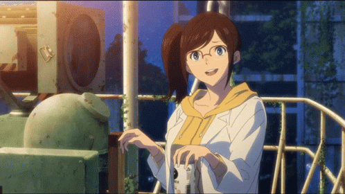 A Girl With Glasses And A Ponytail Is Standing In Front Of A Fence GIF