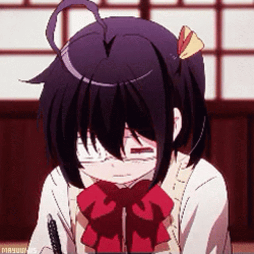 A Girl With Glasses And A Red Bow Tie Is Sitting Down With Her Eyes Closed . GIF