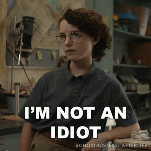 A Girl With Glasses And A Shirt That Says I 'M Not An Idiot On It GIF