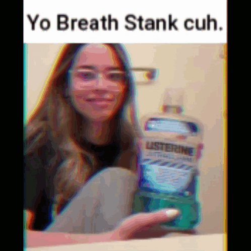 A Girl With Glasses Is Holding A Bottle Of Listerine Mouthwash GIF