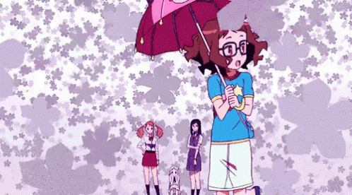 A Girl With Glasses Is Holding An Umbrella In Front Of A Pattern Of Flowers GIF