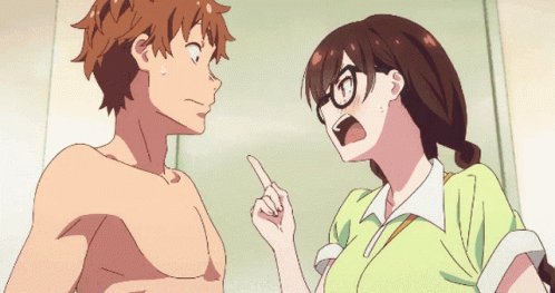 A Girl With Glasses Is Pointing At A Shirtless Guy GIF
