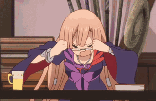 a girl with glasses is sitting at a table with a mug of beer