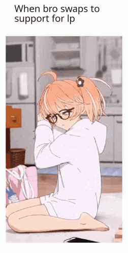 a girl with glasses is sitting on the floor with her head on her knees .