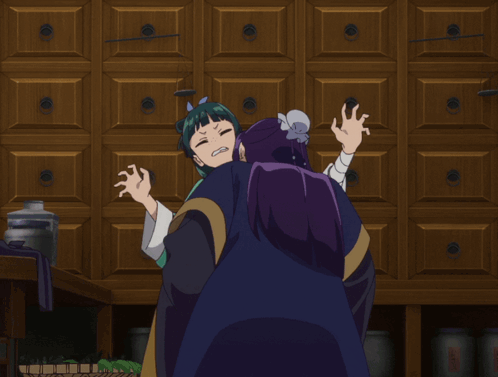 A Girl With Green Hair And Purple Hair Is Hugging A Man With Purple Hair GIF