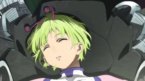 A Girl With Green Hair Is Laying In A Chair GIF