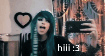 A Girl With Green Hair Is Taking A Selfie With A Cell Phone . GIF