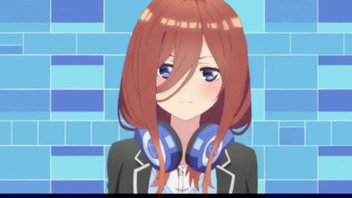 A Girl With Headphones Around Her Neck Is Standing In Front Of A Blue Wall . GIF