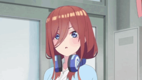 A Girl With Headphones Around Her Neck Is Standing In Front Of A Building . GIF