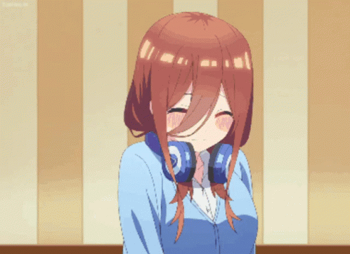 A Girl With Headphones Around Her Neck Makes A Funny Face GIF