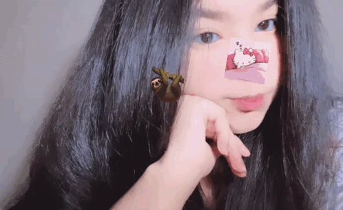 a girl with hello kitty stickers on her face